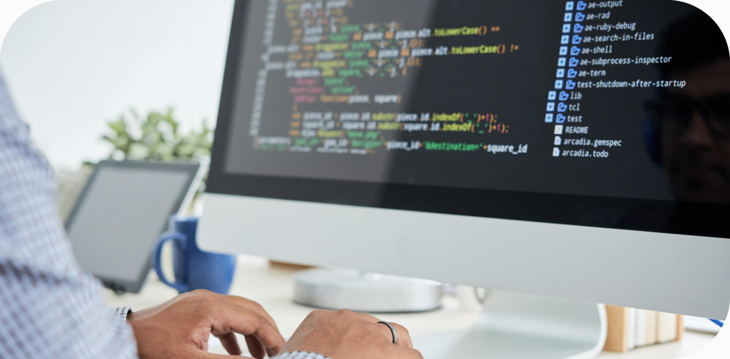 A man in front of a computer writing code